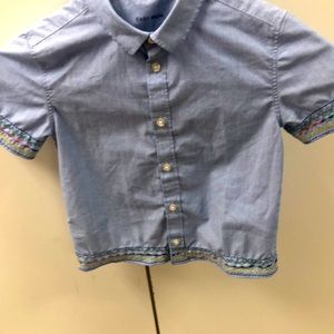 This custom embroidered shirt is one of a kind. It measures 12” across the back.